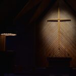 brown wooden cross on brown wooden wall
