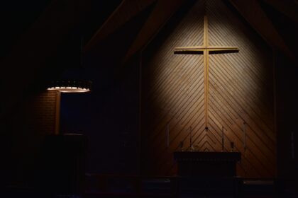 Photo by Josh Eckstein brown wooden cross on brown wooden wall